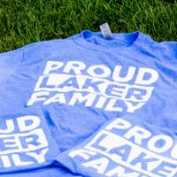 Blue t-shirts with text that reads "Proud Laker Family"